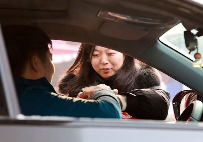 Khách đi xe tặng trà tài xế sau cuốc xe. Ảnh: Xinhua.