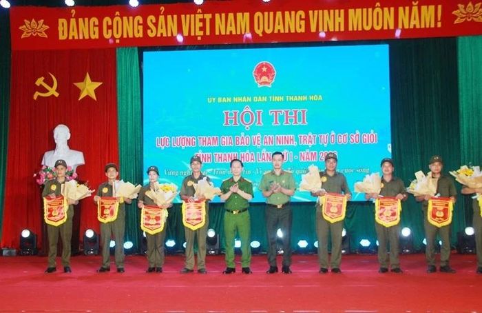 Đại diện lãnh đạo Công an tỉnh tặng cờ lưu niệm cho các đội thi.