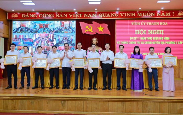Phó Bí thư Thường trực Tỉnh ủy Nguyễn Hồng Phong và Phó Bí thư Tỉnh ủy Trịnh Tuấn Sinh trao Bằng khen của Chủ tịch UBND tỉnh và tặng hoa cho các cá nhân có thành tích xuất sắc trong thực hiện mô hình hệ thống chính trị và chính quyền địa phương 2 cấp.