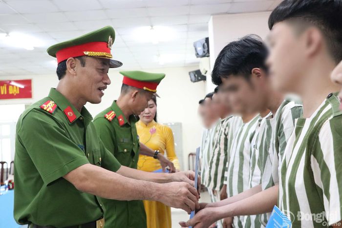 Đại tá Nguyễn Huy Hải, Phó Giám đốc Công an thành phố Đồng Nai trao quyết định đặc xá cho các phạm nhân. Ảnh: Tố Tâm