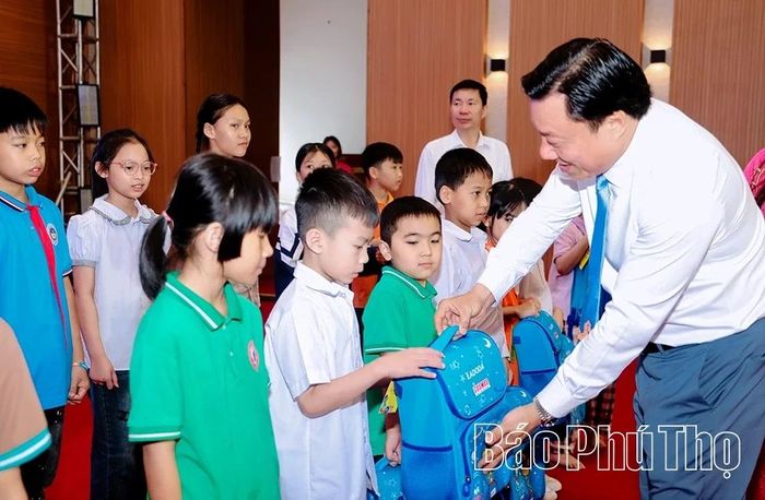 Phó Chủ tịch UBND tỉnh Nguyễn Huy Ngọc trao quà tặng các em học sinh có hoàn cảnh khó khăn.