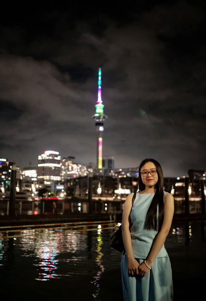 Thùy Nhung chụp ảnh bên Sky Tower, biểu tượng nổi bật của thành phố Auckland, New Zealand.