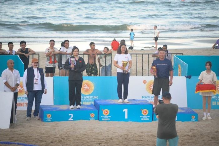 HLV Lương Thị Quyên đại diện Ban huấn luyện đội tuyển U17 Việt Nam nhận cúp vàng cho thành tích nhất toàn đoàn nữ Vật bãi biển U17 châu Á. (Ảnh: Vật VN).