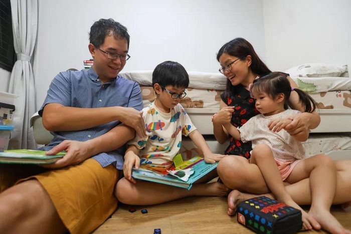 Andrew Fam và vợ đọc sách cho các con.