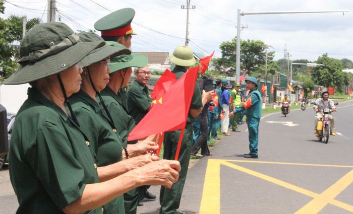  Người dân và lực lượng cựu chiến binh chào đón các liệt sĩ trở về đất mẹ. Ảnh: T.T 