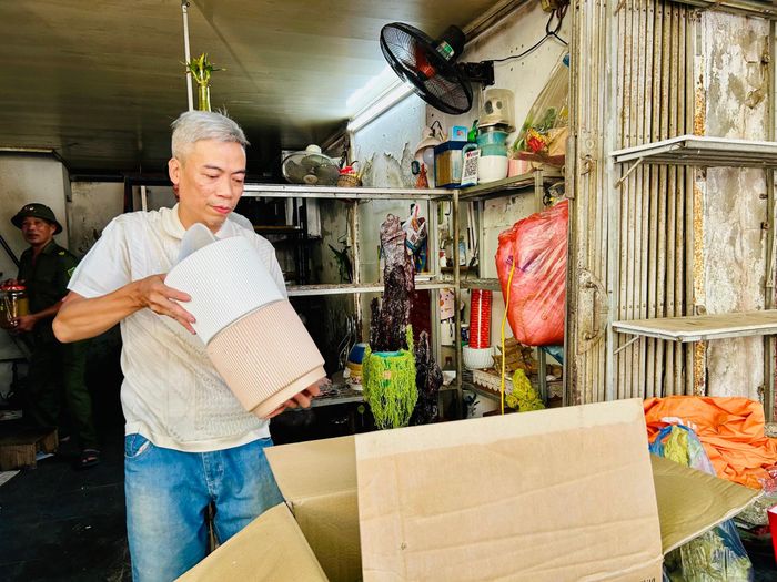 Anh Vũ Hùng Thắng thu dọn đồ đạc, chuẩn bị di dời. Ảnh: Trần Oanh.