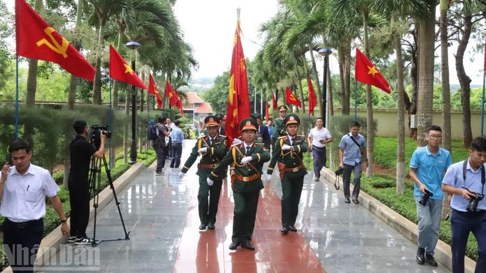 Đoàn quân kỳ đưa các hài cốt liệt sĩ đến nơi an táng.