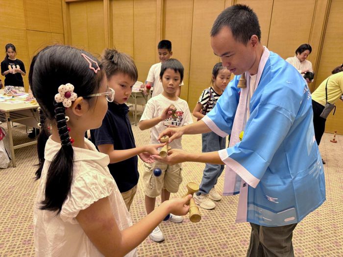 Các em được hướng dẫn chơi Kendama và Wanage - những trò chơi quen thuộc trong các lễ hội của Nhật Bản.