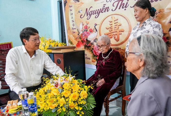 Phó Bí thư Thành ủy Ngô Xuân Thắng thăm hỏi cụ Nguyễn Thị Mậu, năm nay tròn 100 tuổi. Ảnh: HỒ QUÂN