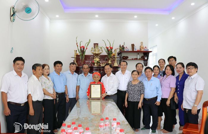 Đoàn công tác trao thiệp mừng thọ của Chủ tịch nước cho cụ Lê Thị Cúc ở khu phố Phú Thanh, phường Bình Phước. Ảnh: Ngọc Huyền