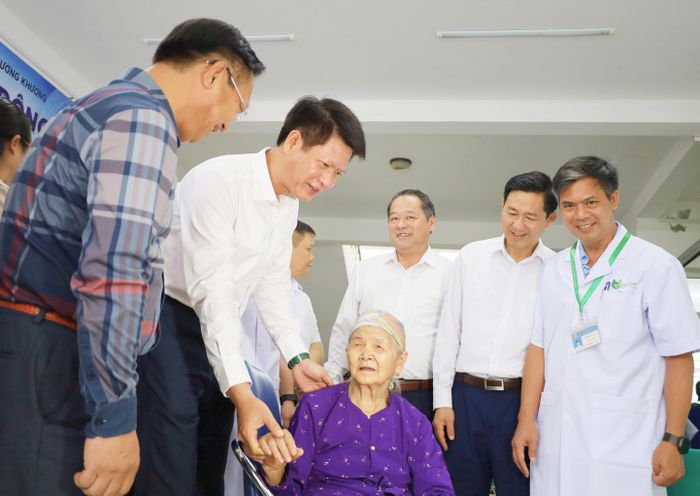 Đồng chí Nguyễn Thế Phước và đoàn công tác ân cần hỏi thăm, động viên người dân tại các bàn khám chữa, bệnh.