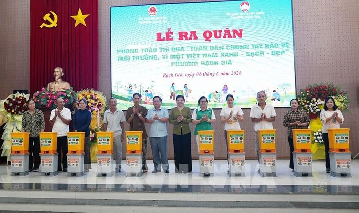 Trao tặng vật dụng chứa và phân loại rác thải cho hộ dân. Lê Huy Hải - TTXVN