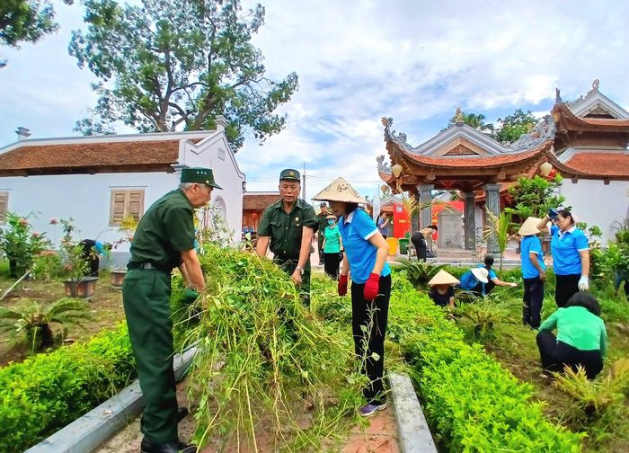 Các đại biểu tham gia dọn cỏ tại khu vực Văn chỉ Nguyệt Áng. Ảnh: Hoàng Quyết