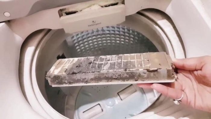 Với máy giặt cửa trên, bộ lọc cặn thường có dạng túi lưới hoặc khay nhựa nằm bên trong lồng giặt. Ảnh minh họa.