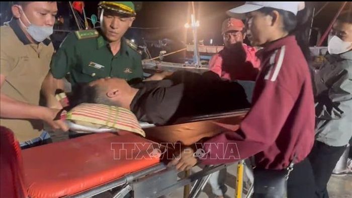 Lực lượng biên phòng đưa ngư dân Võ Kế Luân (27 tuổi) vào bờ để cấp cứu. Ảnh: TTXVN phát
