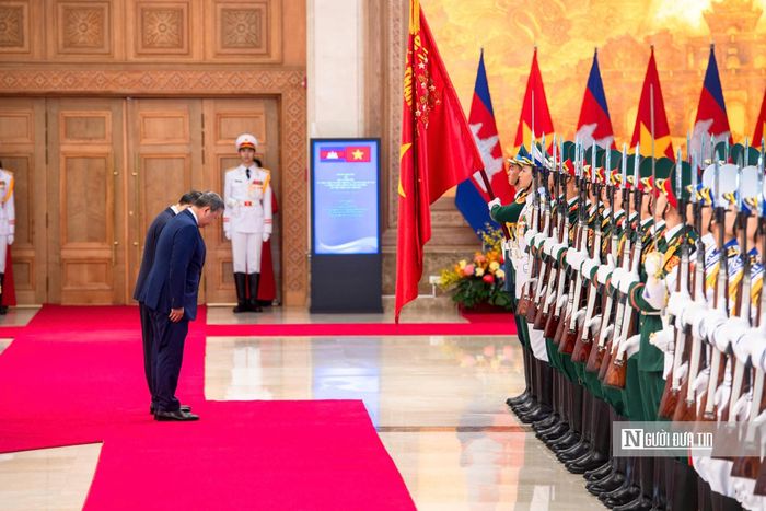 Thủ tướng Lê Minh Hưng và Thủ tướng Hun Manet cúi chào Quân kỳ Quyết thắng.