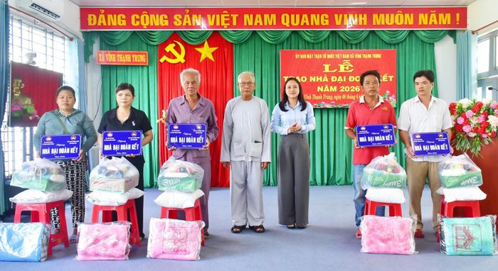 Trao bảng tượng trưng bàn giao nhà đại đoàn kết cho các hộ dân.