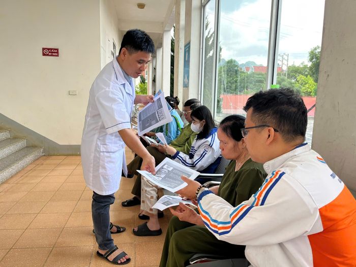 Cán bộ Trung tâm Kiểm soát bệnh tật tỉnh phát tờ rơi, hướng dẫn người dân phòng bệnh Ebola.