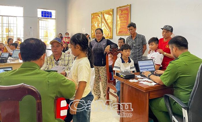 Cán bộ Công an xã Cái Nước cấp định danh điện tử cho trẻ em, học sinh vào mỗi cuối tuần.