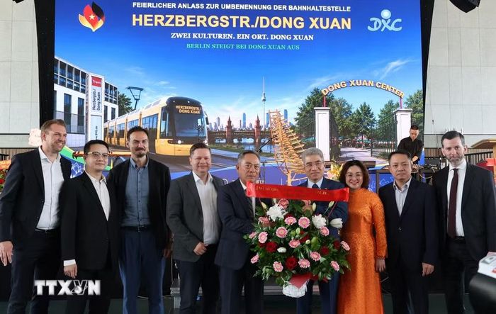 Đại sứ Nguyễn Đắc Thành và Phu nhân tặng hoa chúc mừng ông Nguyễn Văn Hiền, Tổng giám đốc TTTM Đồng Xuân Berlin. (Ảnh: Thu Hằng/TTXVN)