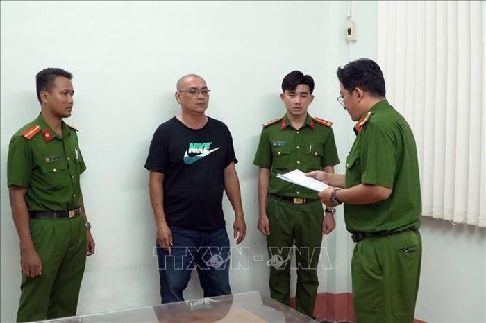 Cơ quan Cảnh sát điều tra Công an thành phố Cần Thơ tống đạt Quyết định khởi tố và bắt tạm giam đối với bị can Nguyễn Hoàng Nhật. Ảnh: TTXVN phát