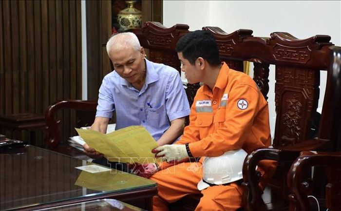 Công nhân EVNHANOI tuyên truyền phòng chống chấy nổ tới người dân.