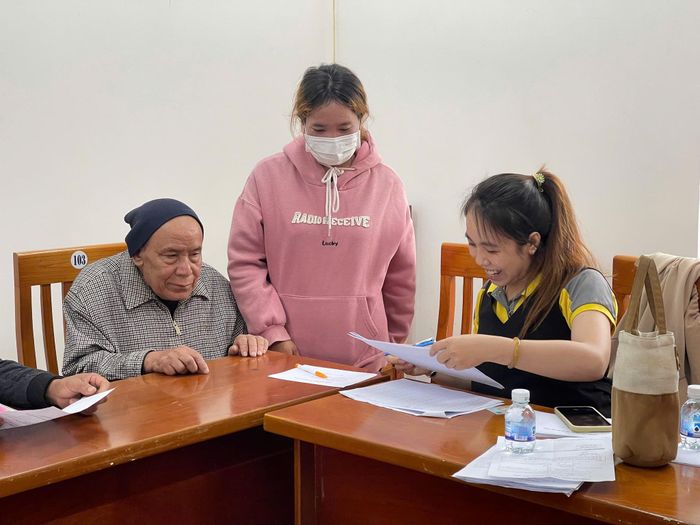 Người dân nhận giấy mời và hướng dẫn quy trình chi trả tiền mặt từ đơn vị thực hiện dự án