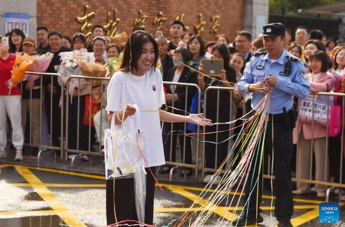 Một nữ sinh được chào mừng bằng những dải ruy-băng nhiều màu sau khi làm bài thi ở tỉnh Cát Lâm, ngày 9/6. Ảnh: Zhangnan/ Xinhua.