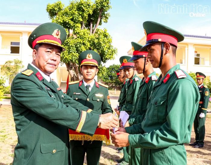 Đại tá Trần Tấn Cường trao quà cho chiến sĩ mới.