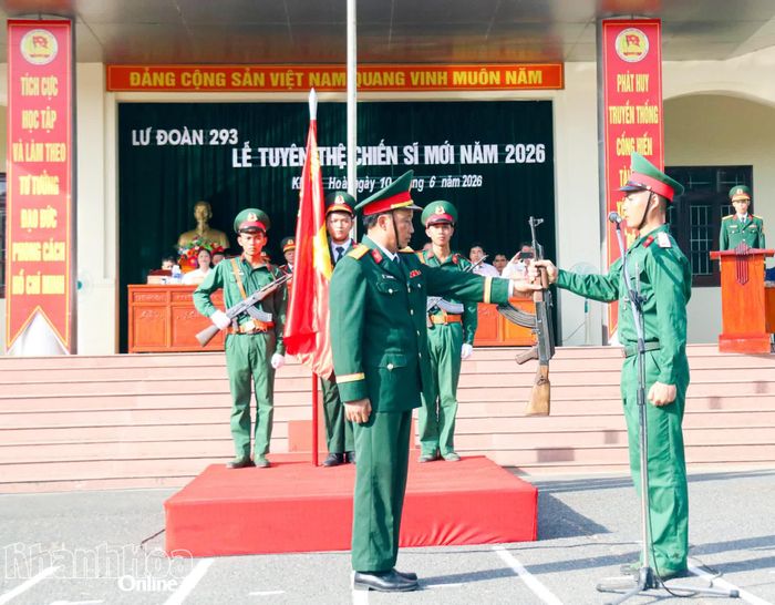 Đại tá Phạm Văn Chuyên thực hiện nghi thức trao súng cho chiến sĩ mới.