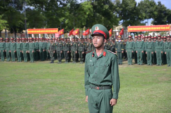 Chiến sĩ mới trang nghiêm tuyên thệ dưới Quân kỳ Quyết thắng. Ảnh: Phương Vũ