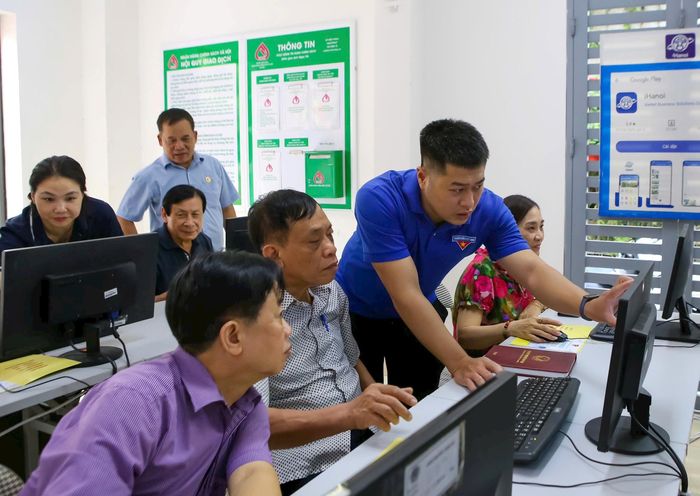 Cán bộ Đoàn Thanh niên phường Ngọc Hà hỗ trợ các cán bộ khu dân cư sử dụng công nghệ AI. Ảnh: Duy Khánh
