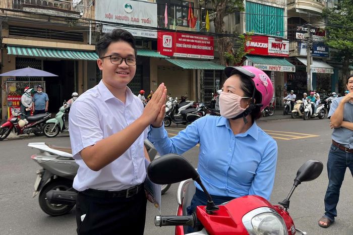Phụ huynh tiếp thêm tinh thần cho con em mình trước khi vào phòng thi. Ảnh: CĐ.