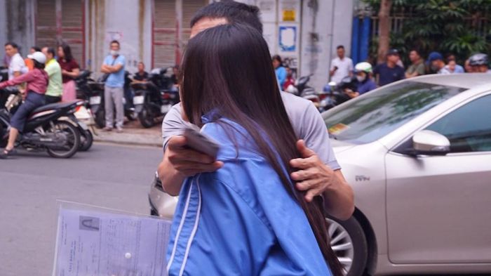 Người cha vui mừng ôm con gái hoàn thành tốt môn thi đầu tiên