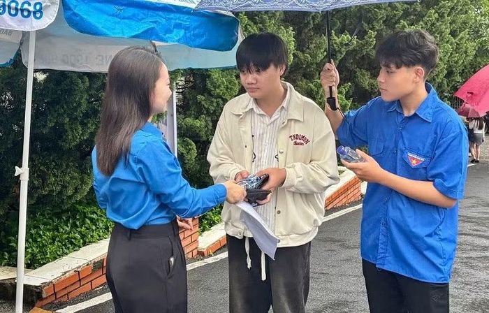 Tình nguyện viên động viên thí sinh tại điểm thi trên địa bàn phường Điện Biên Phủ.