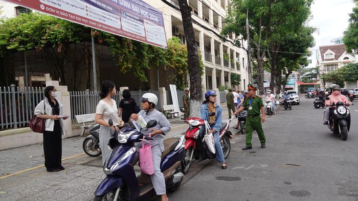 Lực lượng chức năng phân luồng trước điểm thi THPT Trần Phú. Ảnh: XUÂN QUỲNH