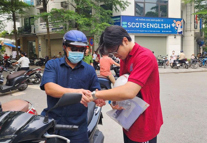 Phụ huynh đưa con tới điểm thi tại Trường THCS Thanh Xuân Trung, phường Thanh Xuân, Hà Nội.