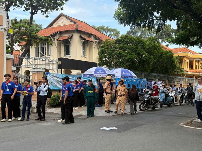 Lực lượng sinh viên tình nguyện và Cảnh sát giao thông hỗ trợ thí sinh tại trường THPT chuyên Lê Hồng Phong, Phường Chợ Quán, TP Hồ Chí Minh.