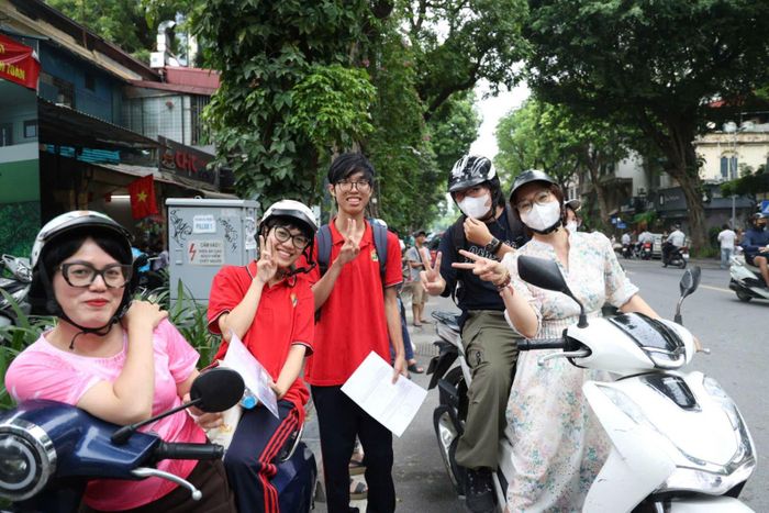 Thí sinh vui vẻ tạo dáng với phụ huynh sau môn thi Toán tại Hà Nội.