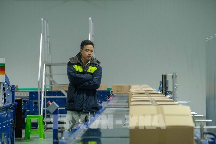 Phân loại và kiểm soát hàng hóa trên băng chuyền trong nhà máy chiếu xạ của Công ty cổ phần Hạnh Nguyên Logistics. Ảnh: Thanh Liêm - TTXVN