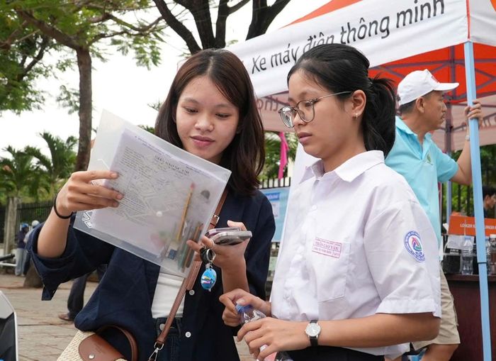 Thí sinh trao đổi bài tại điểm thi Trường THPT chuyên Nguyễn Bỉnh Khiêm (phường Bàn Thạch) sau môn thi đầu tiên. Ảnh: HỒ QUÂN