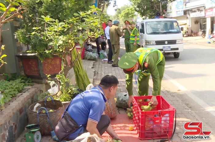 Công an phường Mộc Sơn tuyên truyền, nhắc nhở người dân không bán hàng trên vỉa hè.