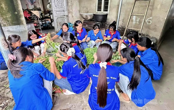 Đoàn viên xã Thanh Thủy tranh thủ nhặt rau, chuẩn bị nguyên liệu để nấu các suất ăn miễn phí cho thí sinh. Ảnh: Trần Kế