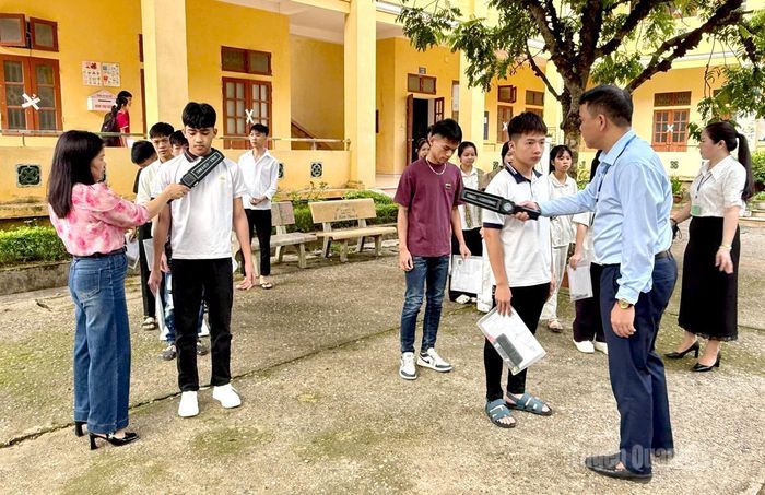 Các thí sinh tại điểm thi trường THPT Đầm Hồng được kiểm tra trước khi vào phòng thi. Ảnh: Trang Hoàng