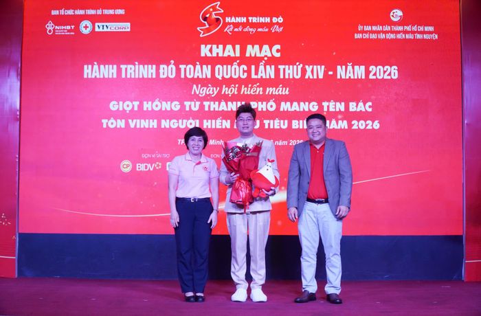 Đại diện Ban tổ chức trao hoa cảm ơn ca sĩ Sỹ Luân đã đồng hành nhiều năm cùng chương trình Hành trình Đỏ
