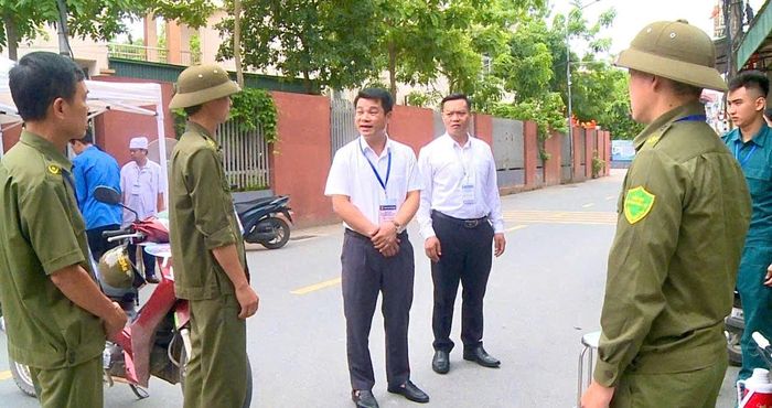 Lãnh đạo xã Hát Môn động viên các lực lượng thực hiện nhiệm vụ tại các điểm thi. Ảnh: HM