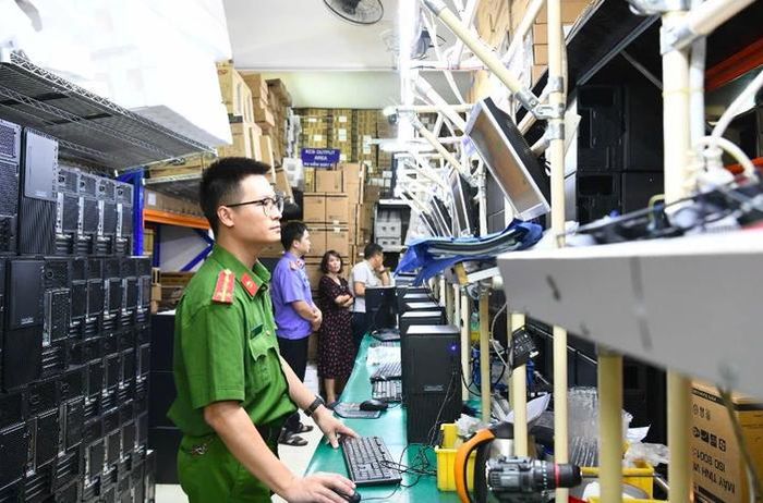 Kiểm tra các thiết bị tại Công ty Cổ phần Truyền thông và Máy tính Thánh Gióng. Ảnh: Công an cung cấp