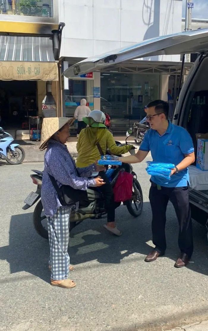 Hỗ trợ áo mưa và nước suối cho người bán vé số ở Đồng Tháp