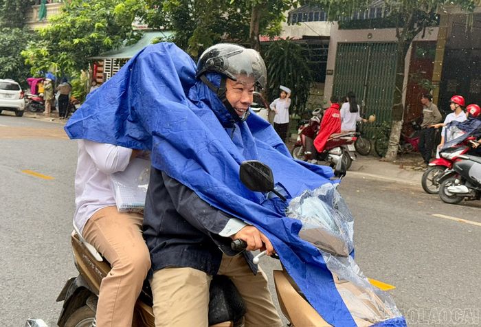 Cha mẹ và các sĩ tử tại điểm thi Trường THPT Lào Cai, phường Lào Cai phấn khởi sau ngày thi cuối cùng dù có cơn mưa rào bất chợt