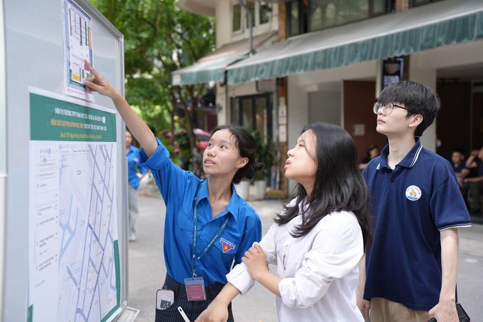 Lực lượng thanh niên hỗ trợ thí sinh tìm phòng thi nhanh chóng. Ảnh: Phạm Mạnh